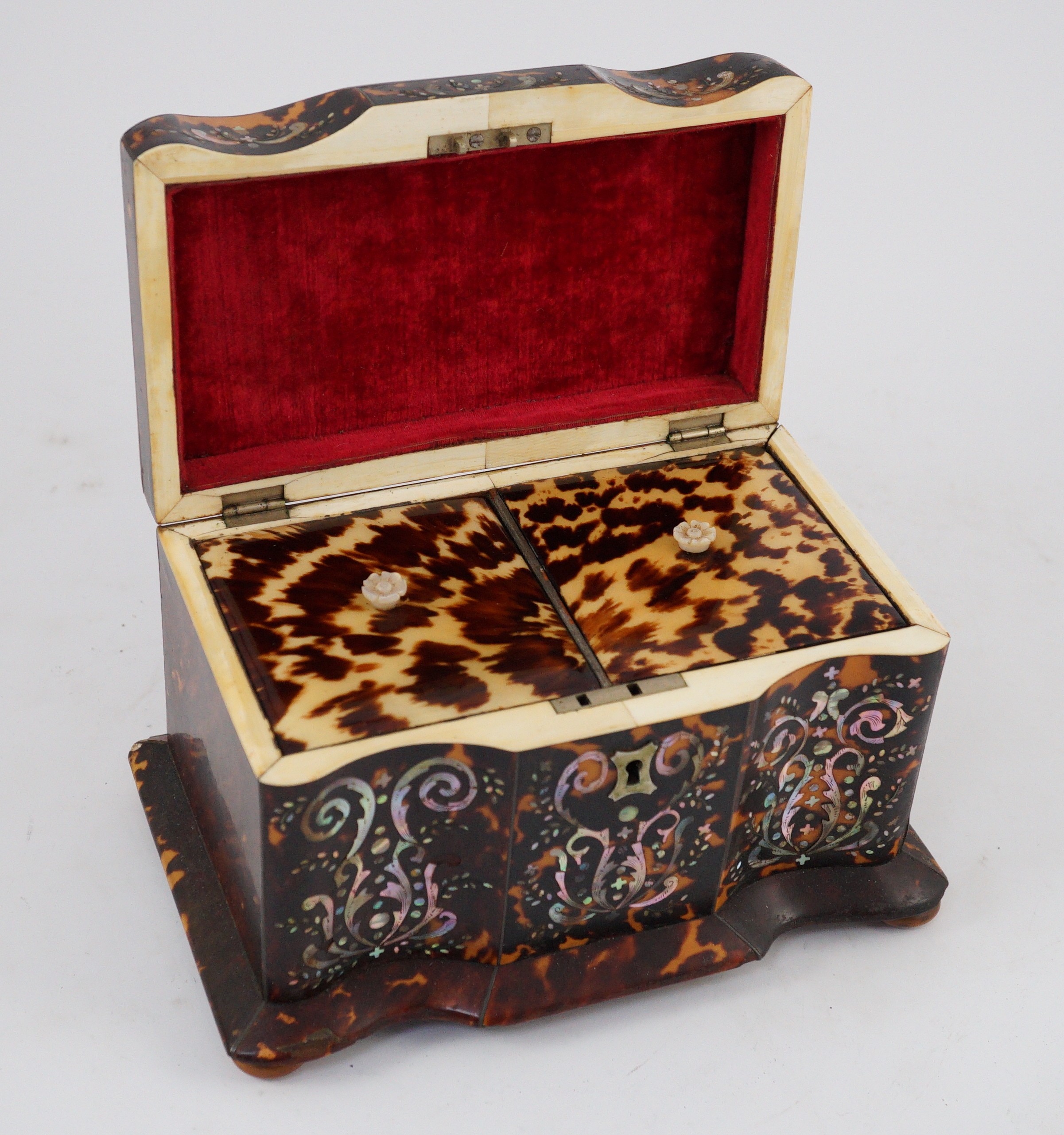 A Regency mother of pearl inset blond tortoiseshell tea caddy, 20cm wide 12.5cm deep 13.5cm high